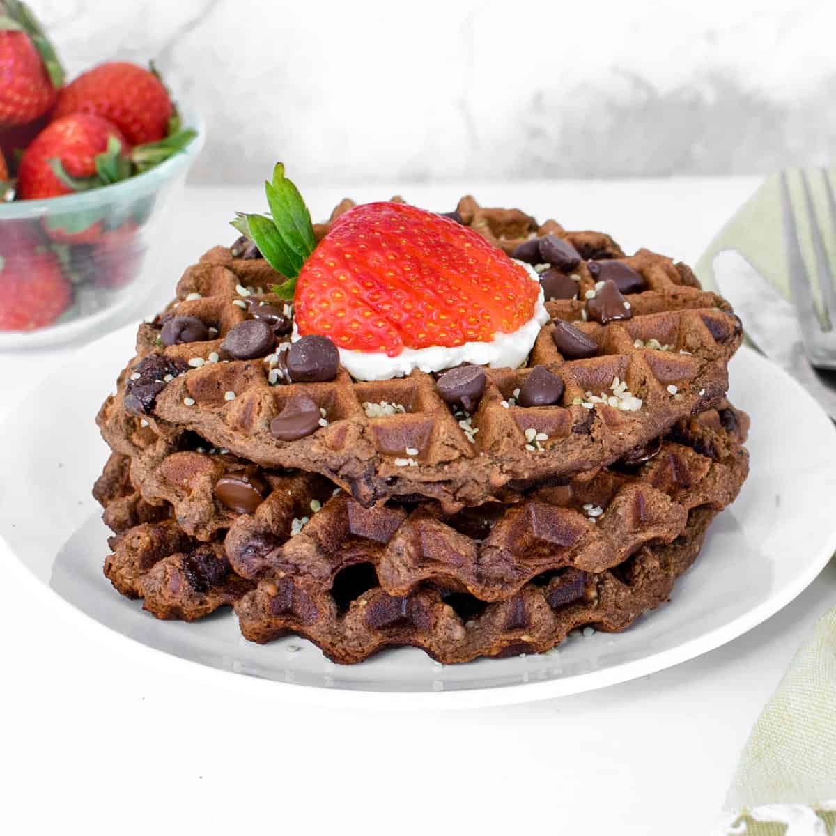 whole waffles stacked with garnishes.