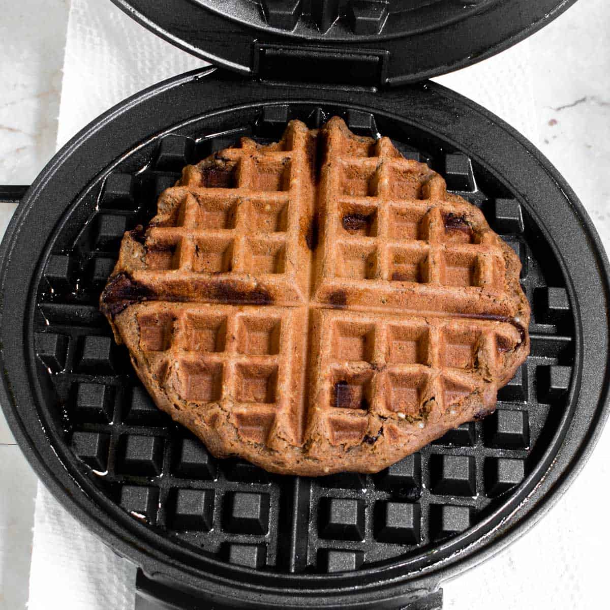 top view of cooked chickpea waffle in the waffle iron.