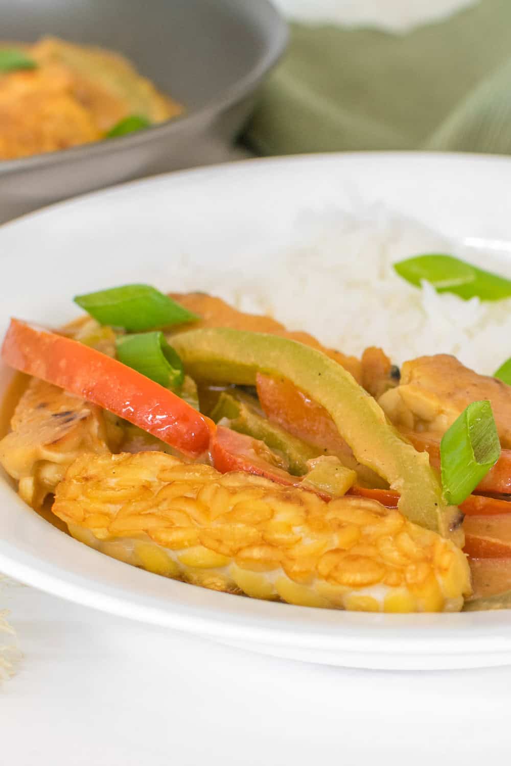 a front view of served tempeh curry with steamed rice.