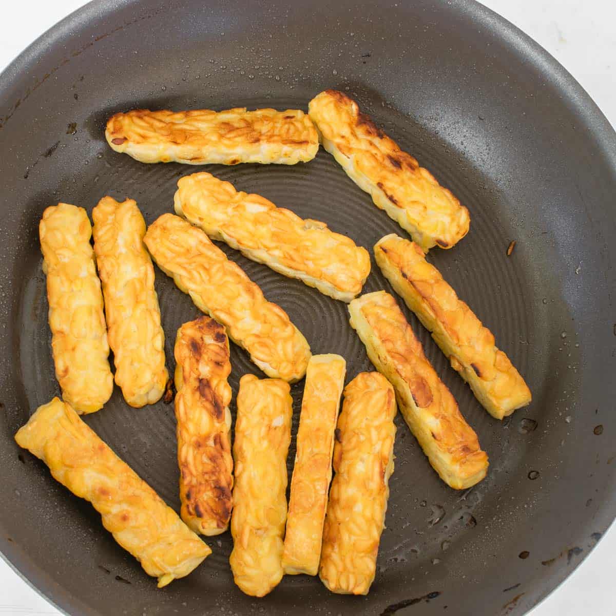 sauteed tempeh in a nonstick pan.