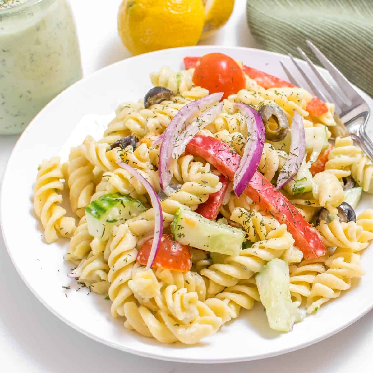 a 45 degree angle view of served tzatziki pasta salad.