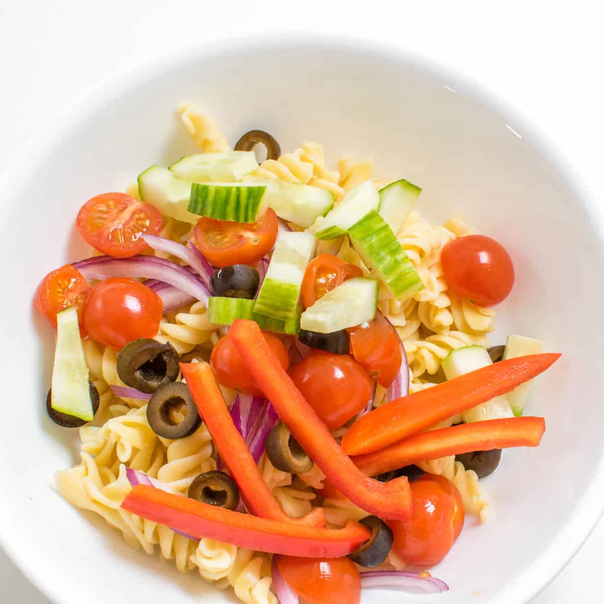 pasta and veggies in a mixing bowl.