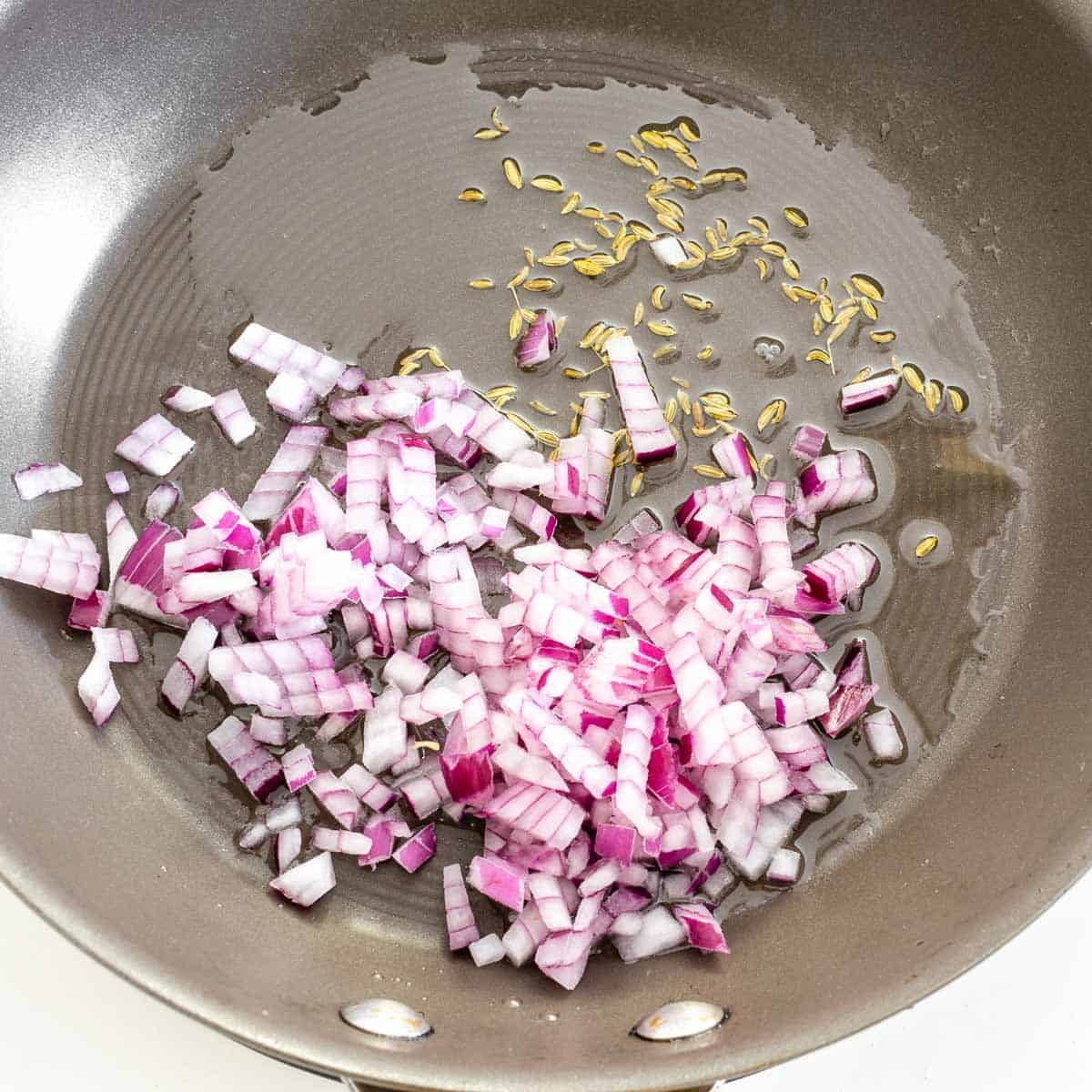 sauteed onion and fennel seeds in a nonstick pan.