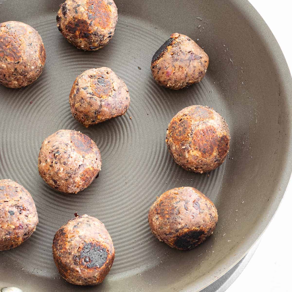 cooked black bean meatballs in the pan. 