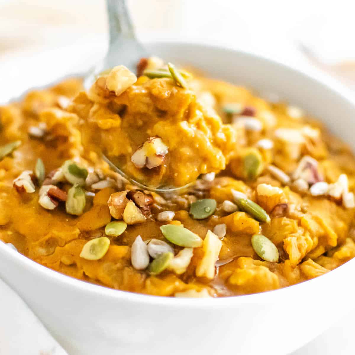 a spoonful of pumpkin oatmeal in focus.