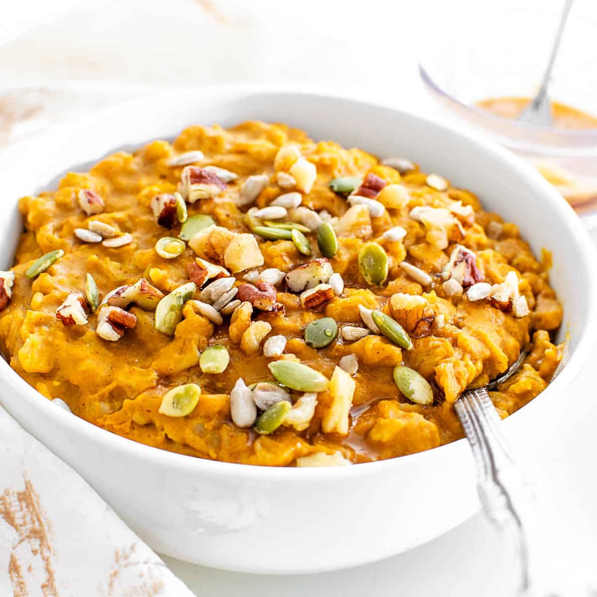 a 45 degree angle view of pumpkin oatmeal in a bowl.