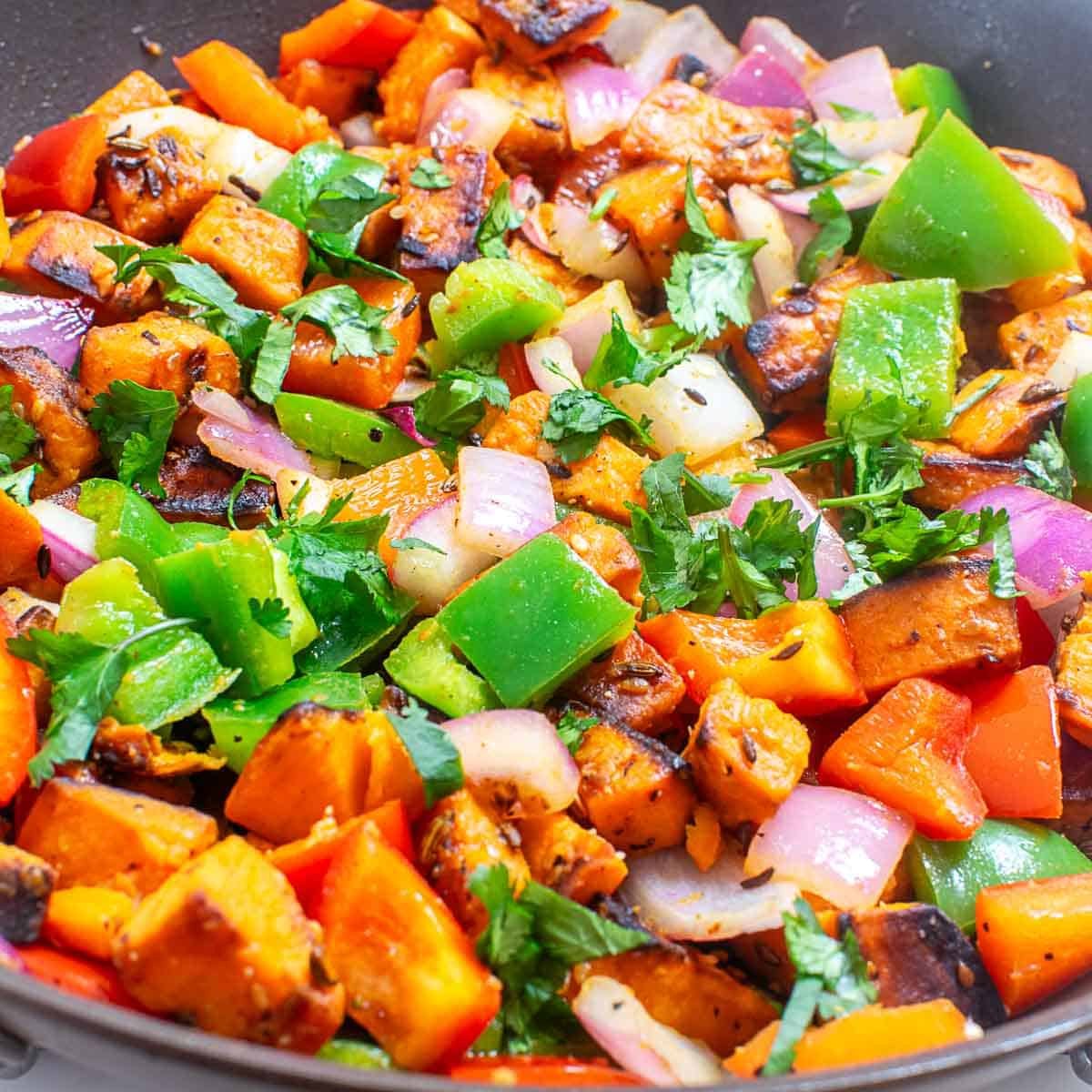 a close up view of sweet potato stir fry in the pan.