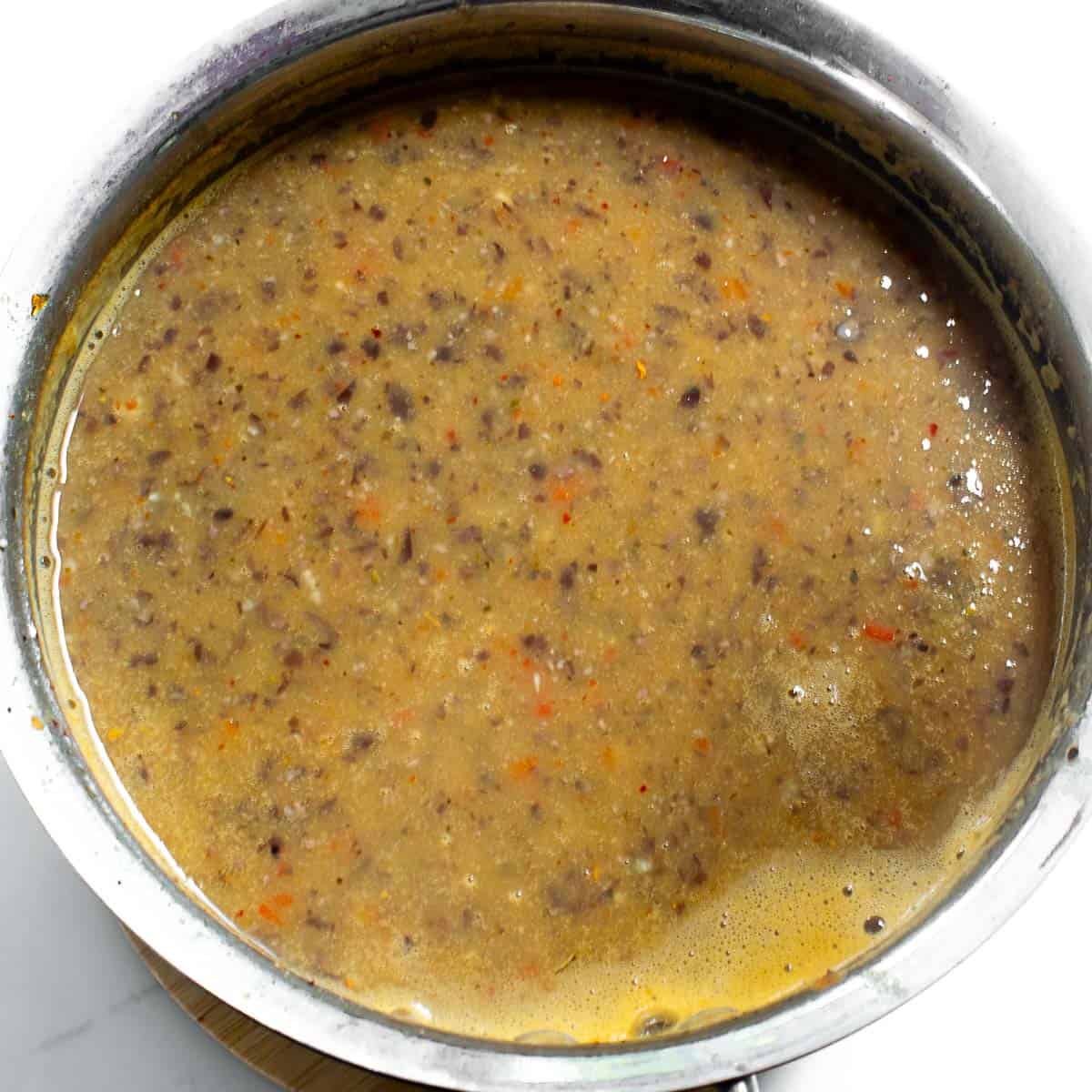 blended soup in the simmering in cooking pot.