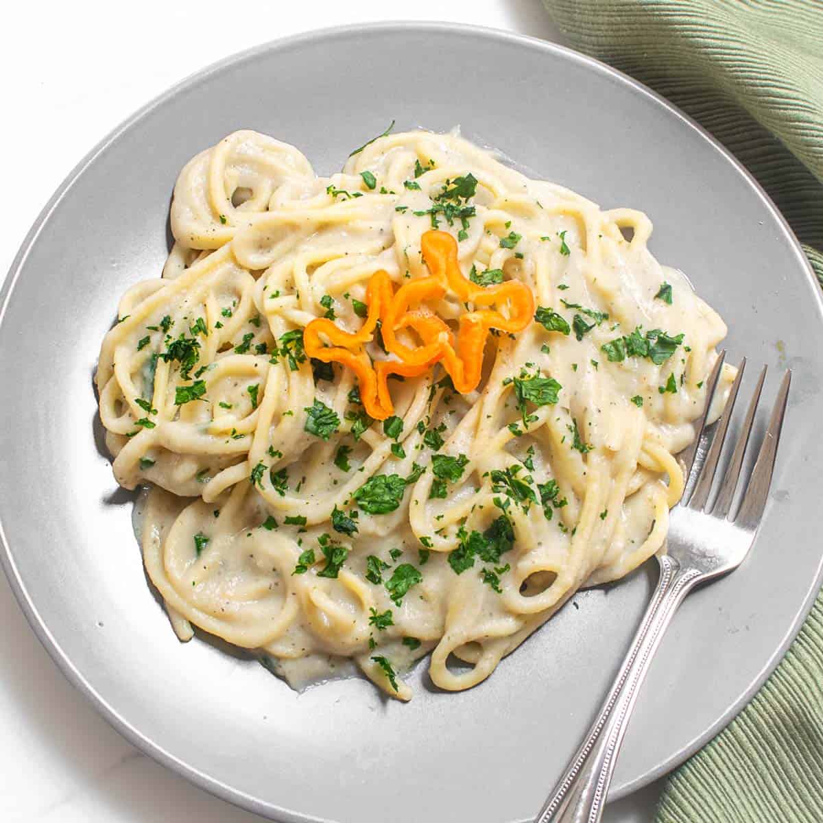 top view of served cauliflower alfredo sauce spaghetti.