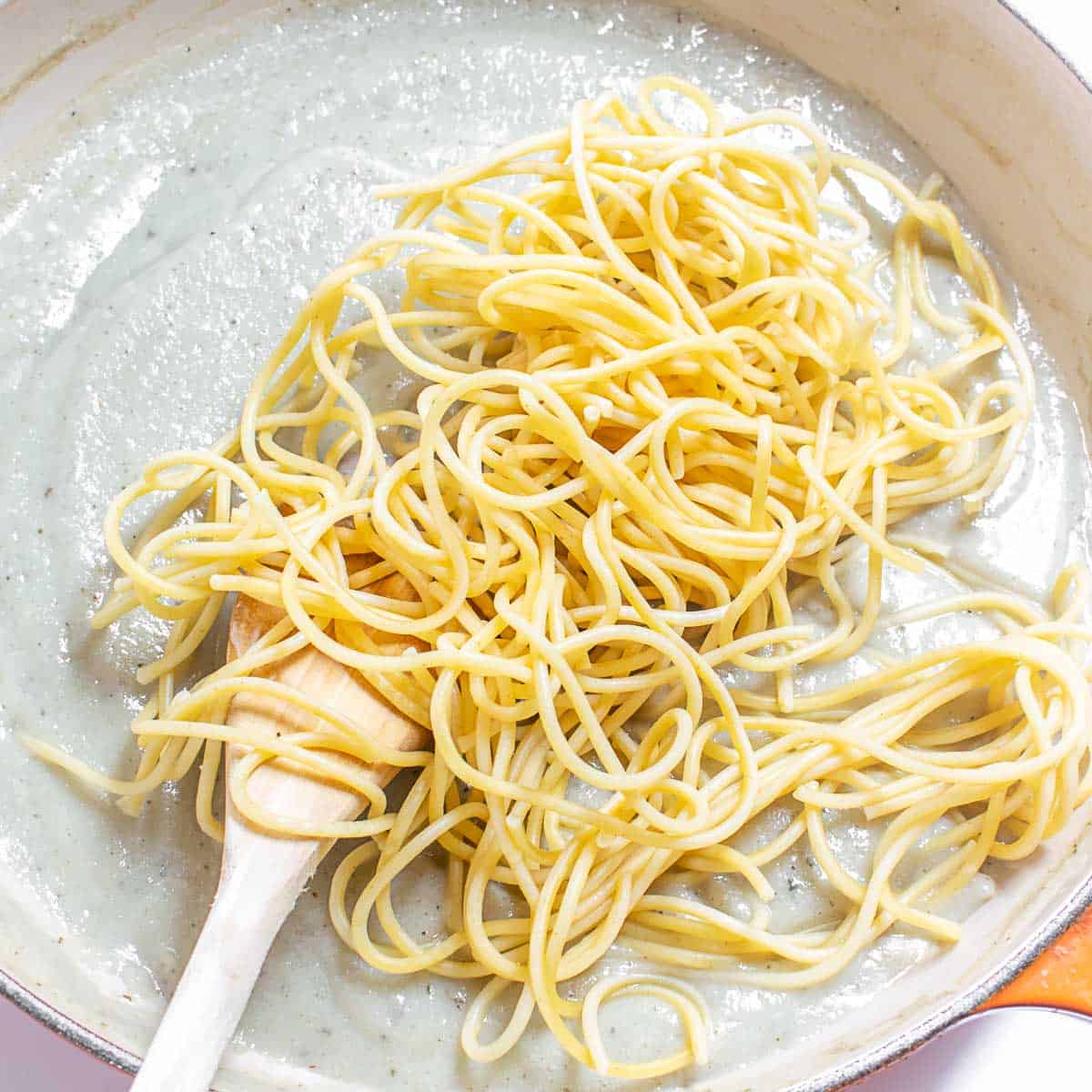 tossed spaghetti in the sauce.