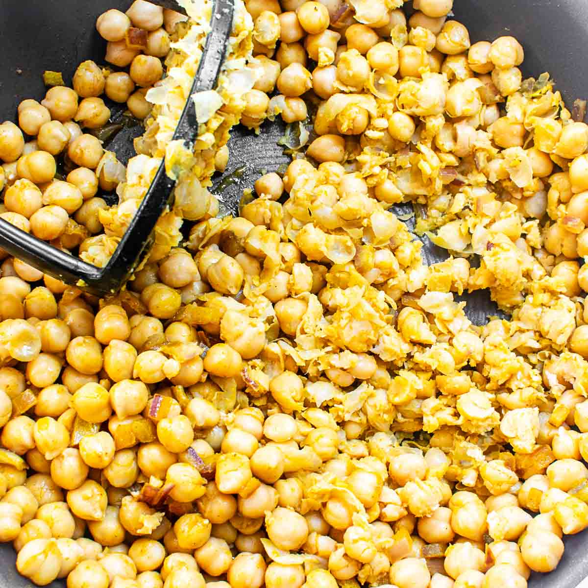 mashed beans in the same pan with the food masher.
