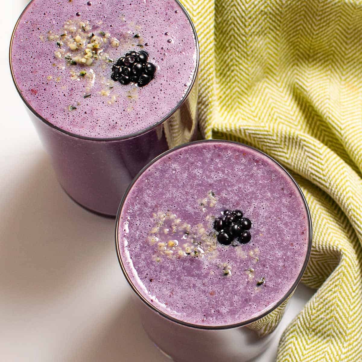 top view of glasses filled with blackberry smoothie.