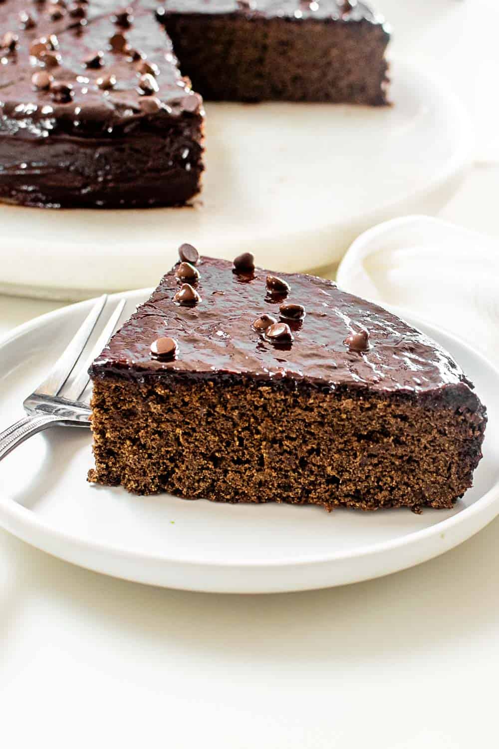 served cake slice with half pie at the background.