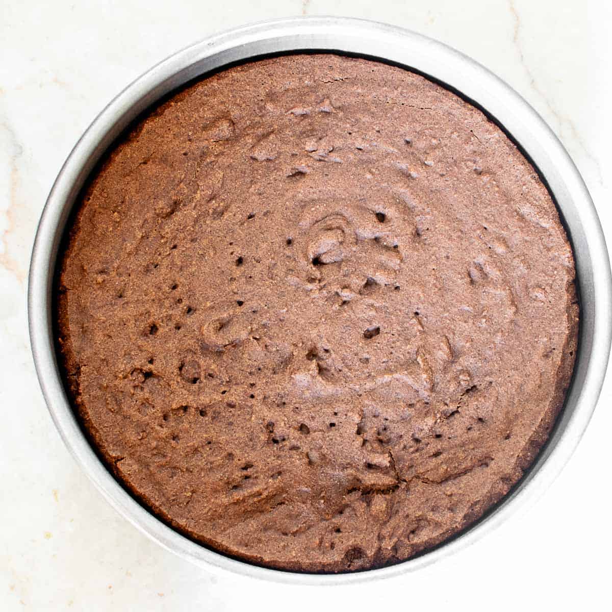 baked chocolate sponge in the pan cooling down.