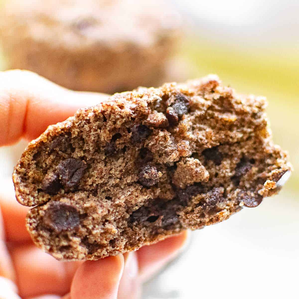 a hand holding 2 halves of the cookie with a close up view.