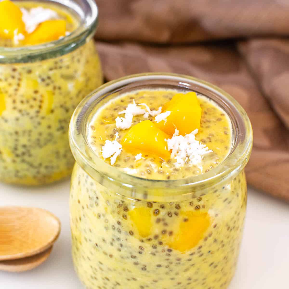a close up view of served mango chia pudding in the serving jars.