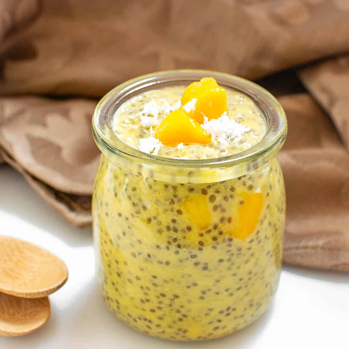a front view of a serving jar filled with mango chia pudding.