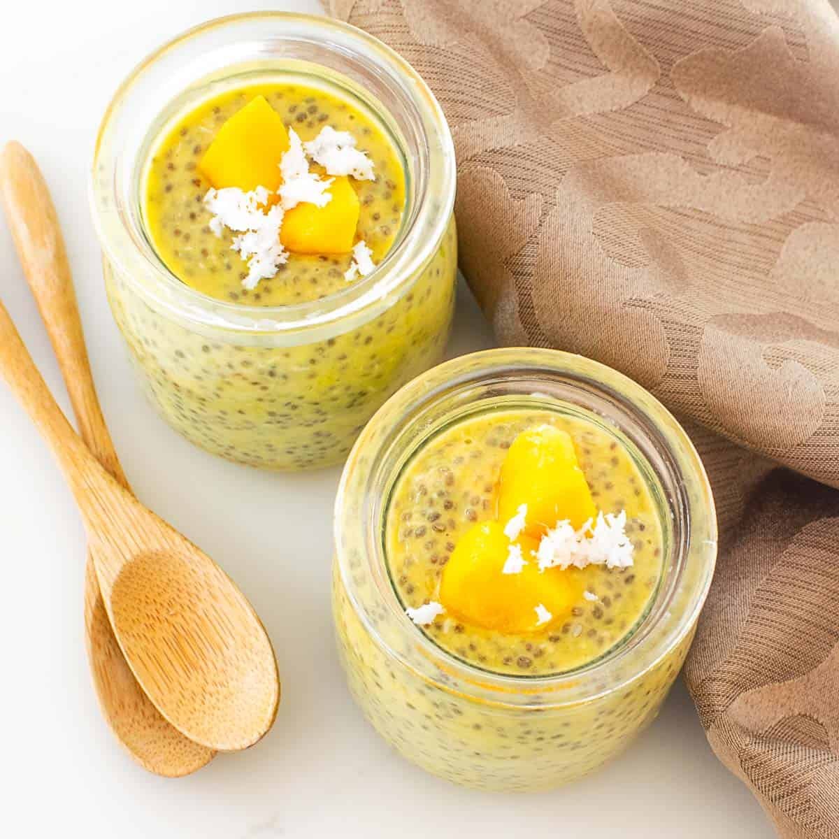 top view of served mango chia pudding with garnishes.