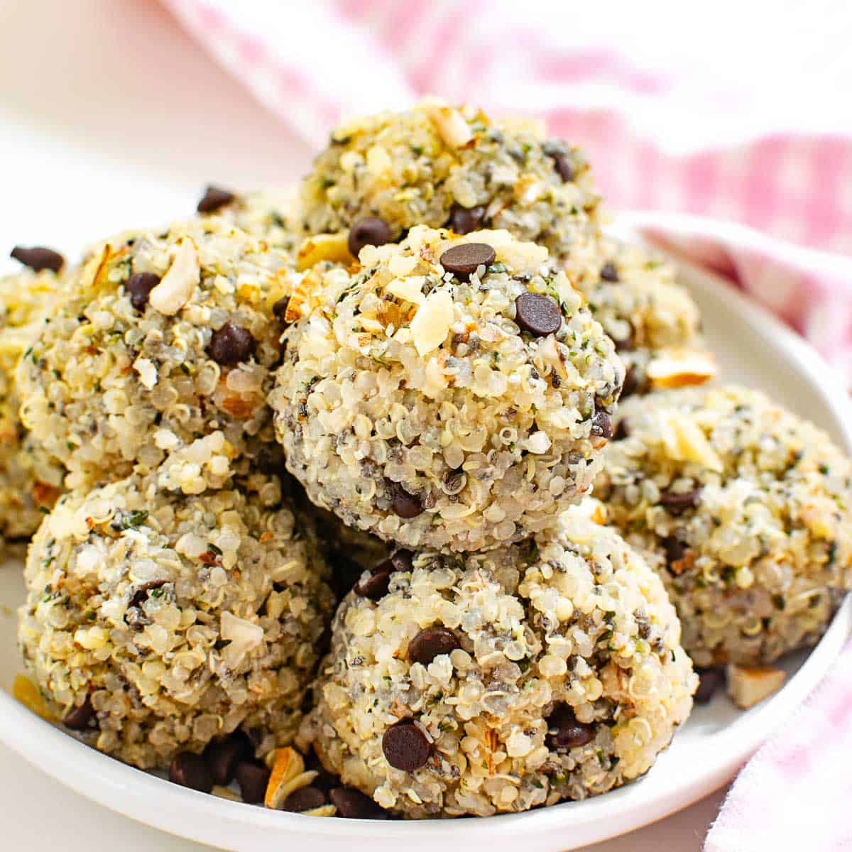 A 45 degree view of stacked quinoa energy balls in a plate.